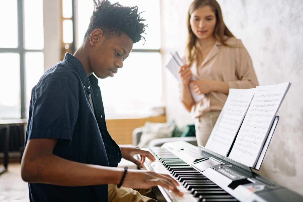 Young student playing the piano