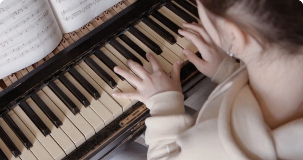 Young student playing the piano