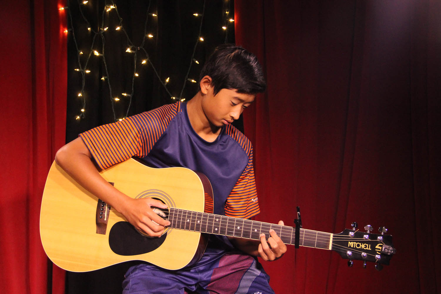 student playing guitar -The Inside Voice