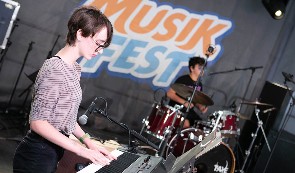 girl playing keyboard and boy playing drums