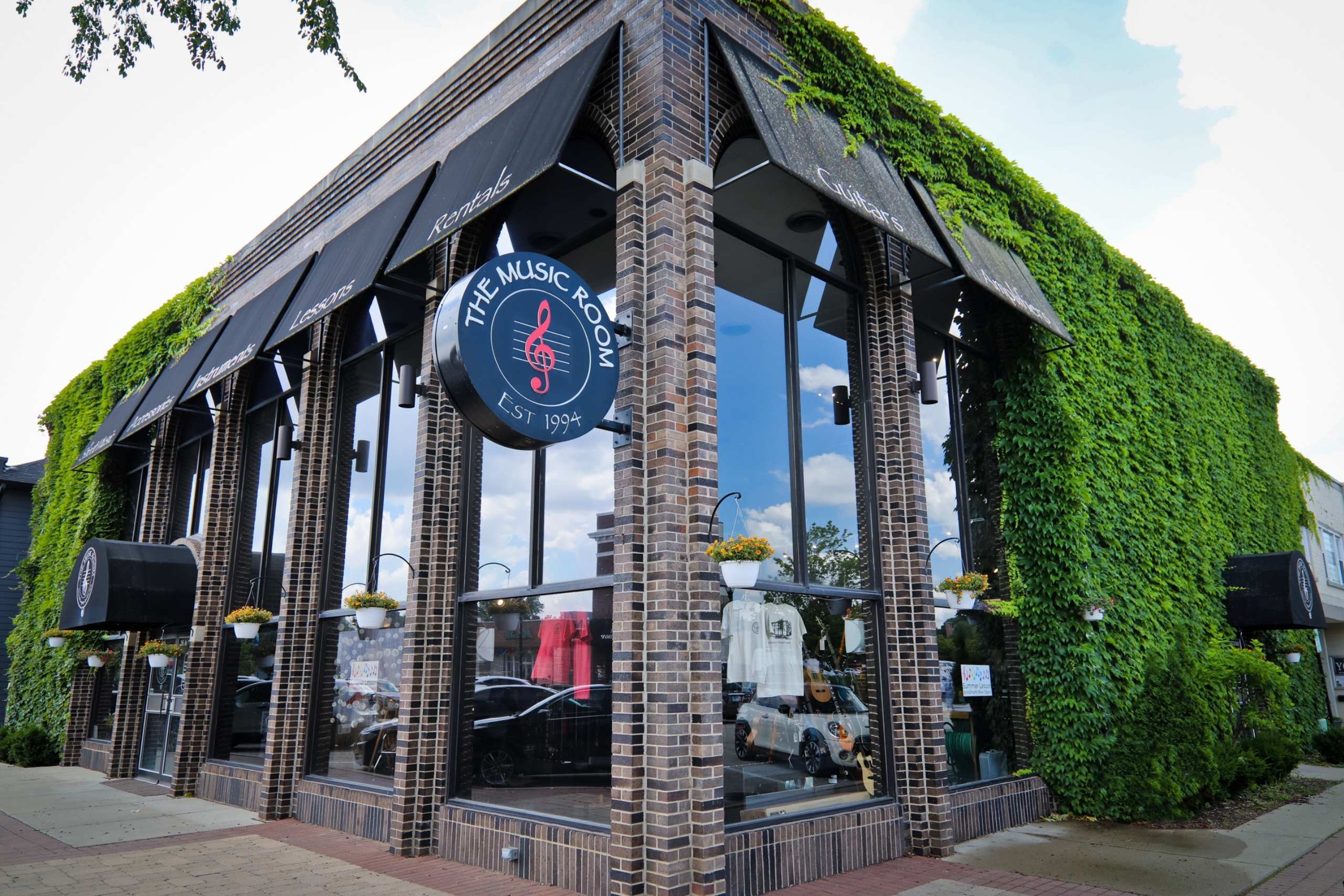 exterior photo of the Music Room bulding, a brick building with Ivy growing up the right side.