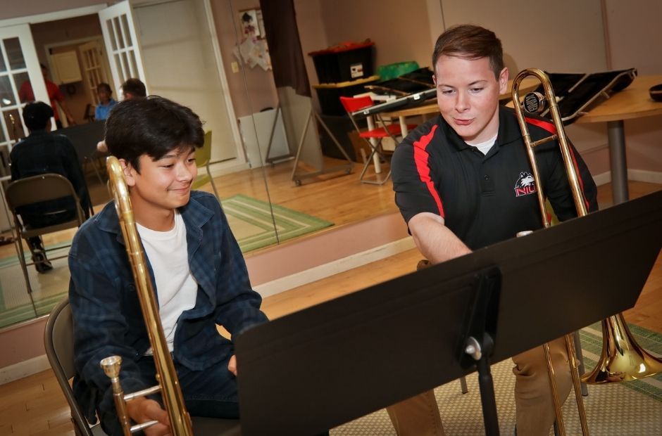 student learning to play the trombone in a lesson