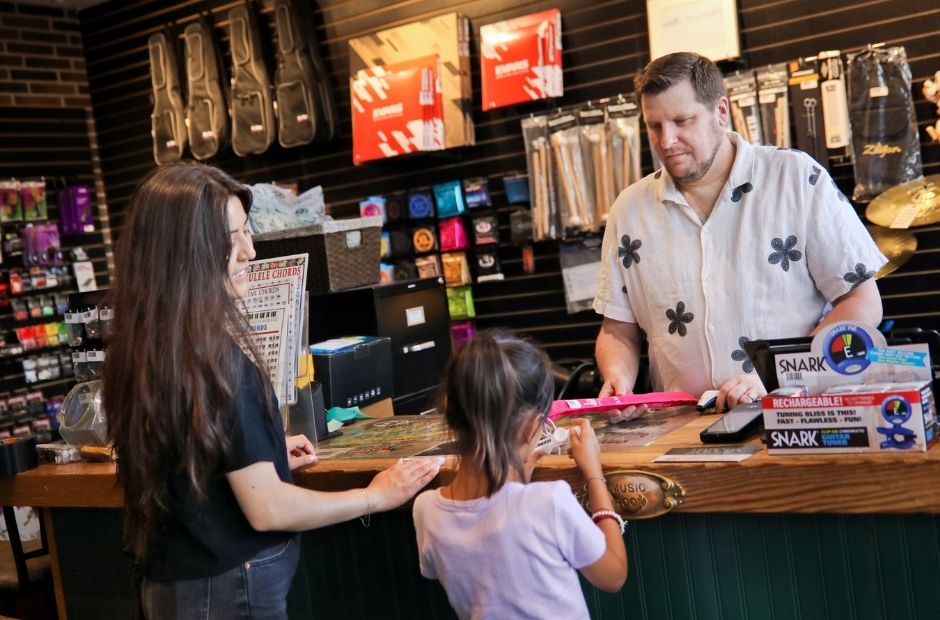 child and mother purchasing a recorder (flute)