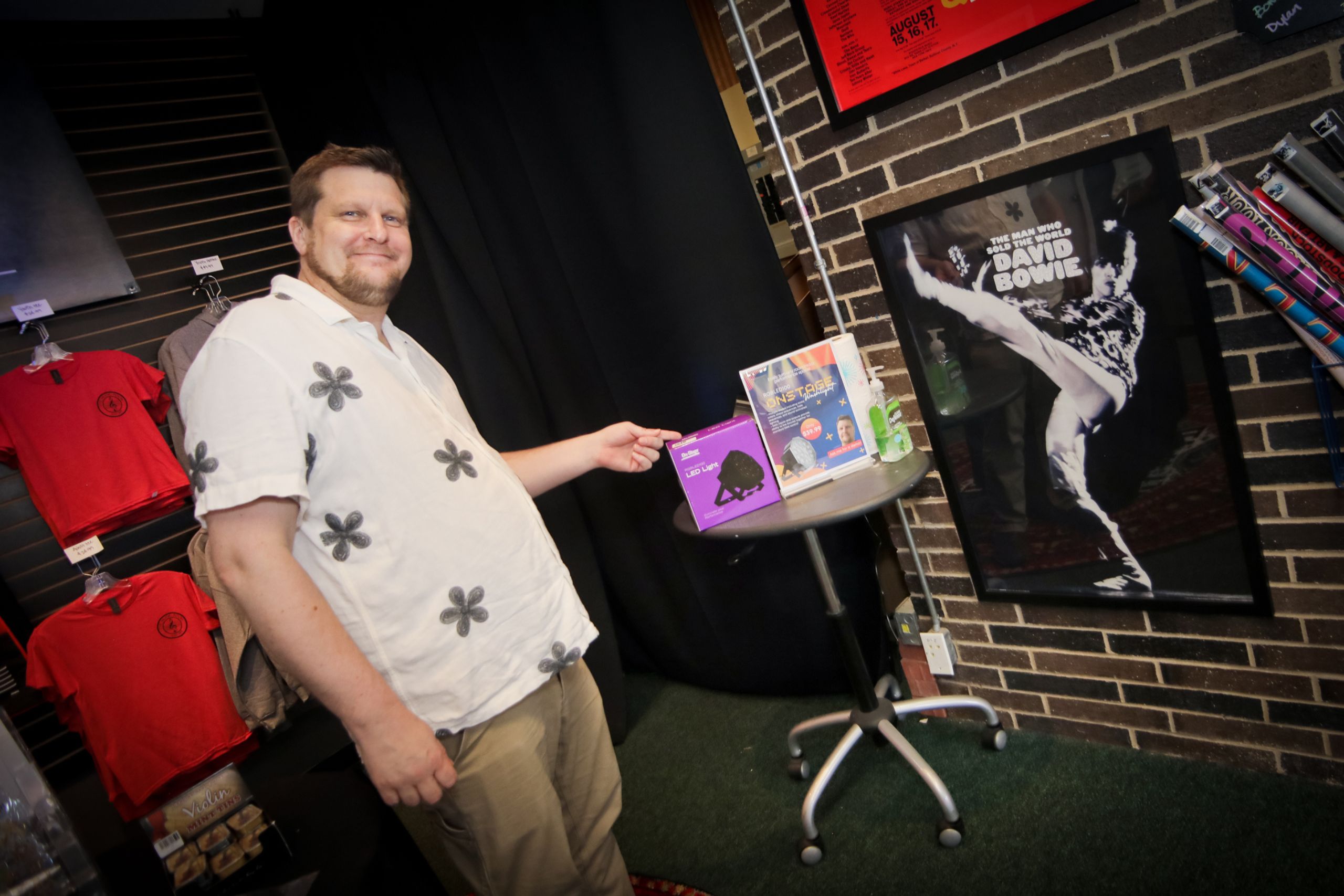 employee standing in front of merchandise