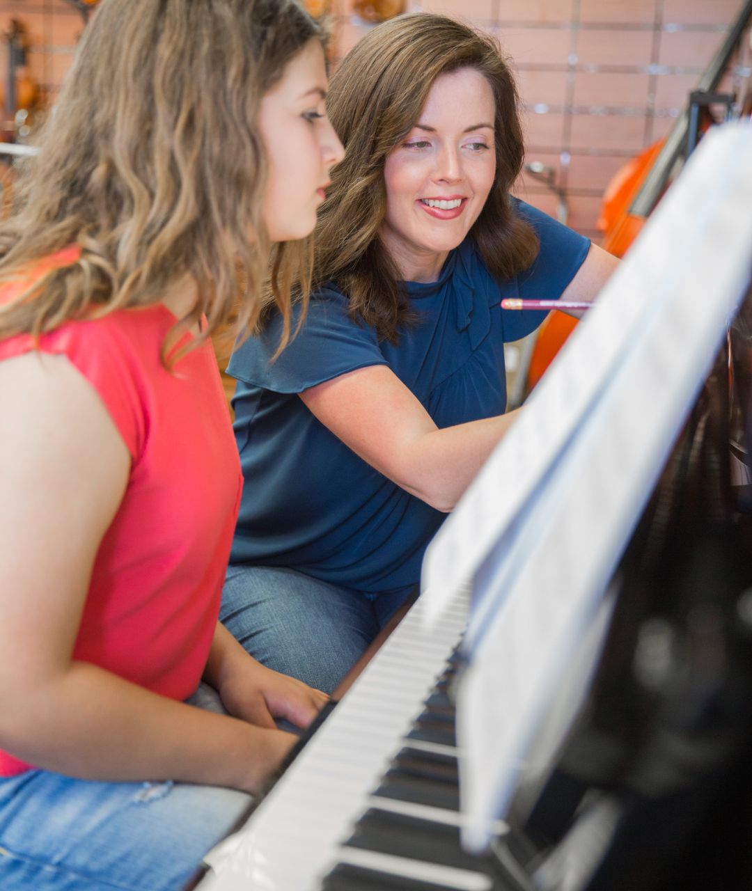piano-teacher-showing-the-student-how-to-play-the-piano
