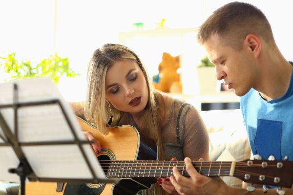 student learning how to play the guitar with a teacher Orland Park IL