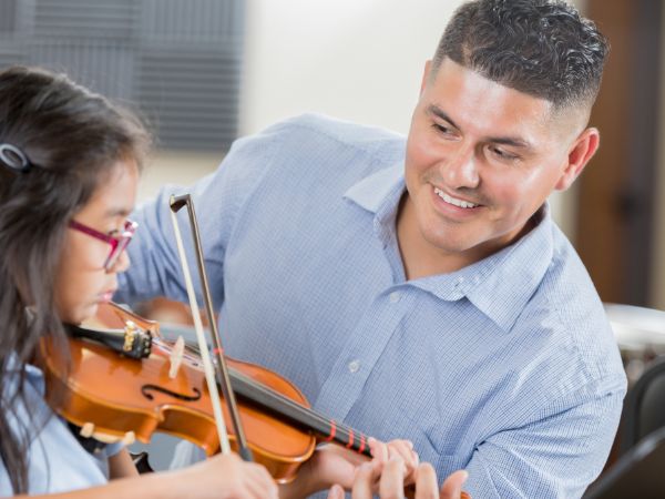 student learning how to play the violin with a teacher Orland Park IL