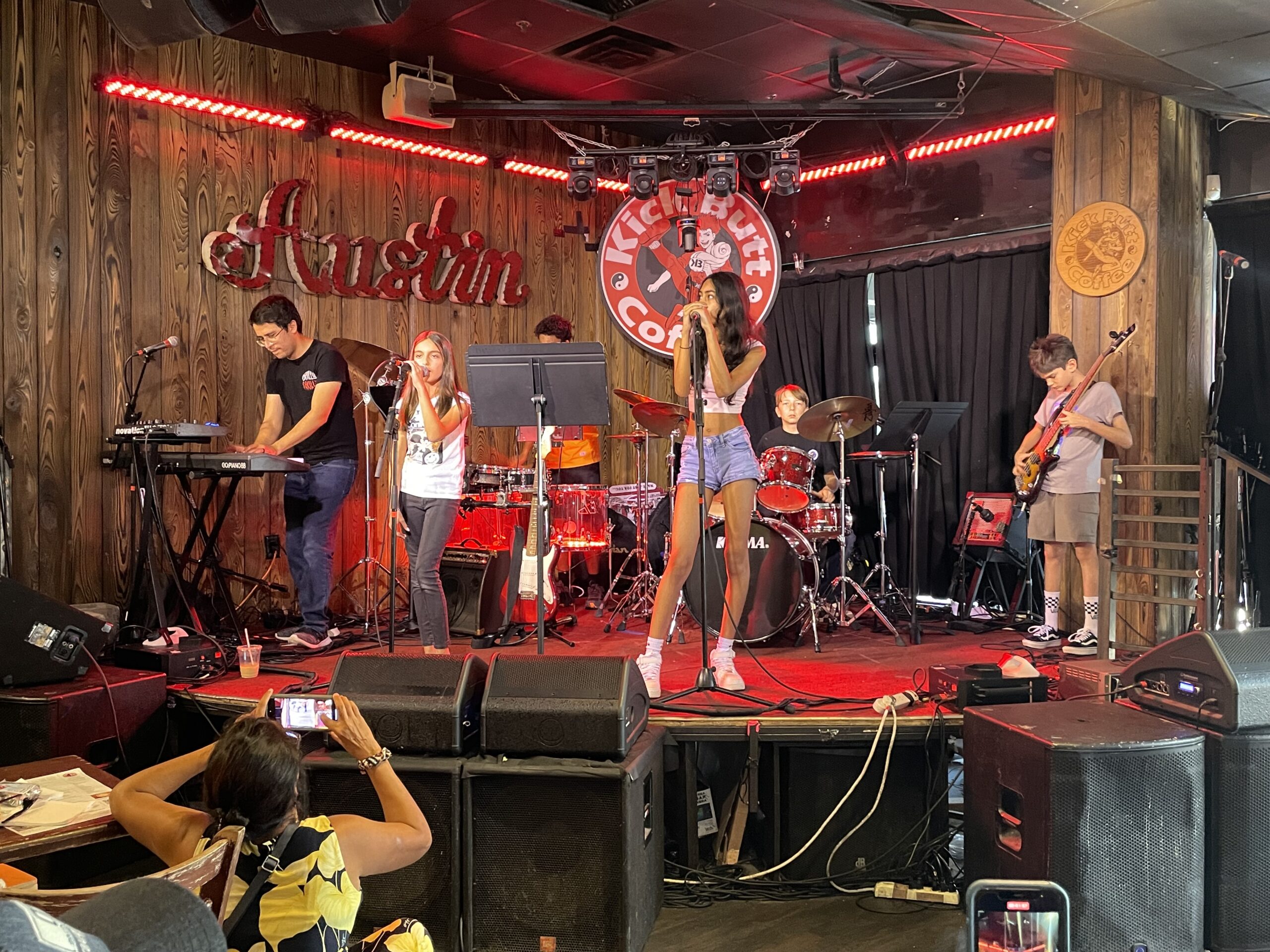 a group of students performing on stage in a rock band