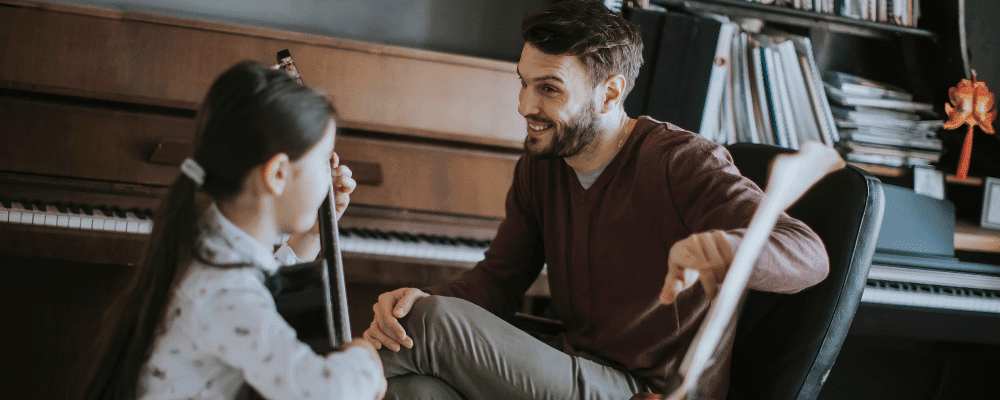 teacher and the girl in guitar lesson