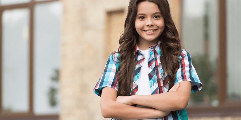 confident girl standing with arms crossed