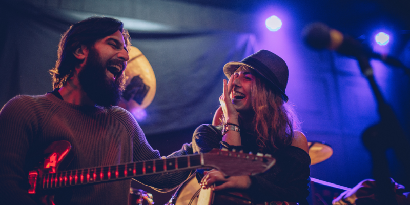 man and woman playing music