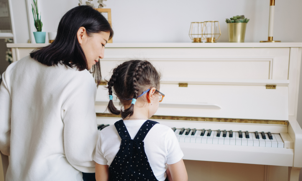 student learning piano with Piano teacher