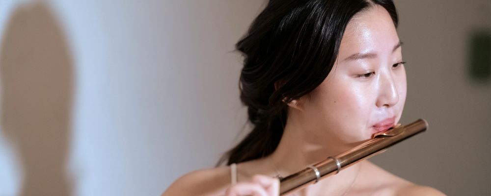 student practicing the flute for the college audition