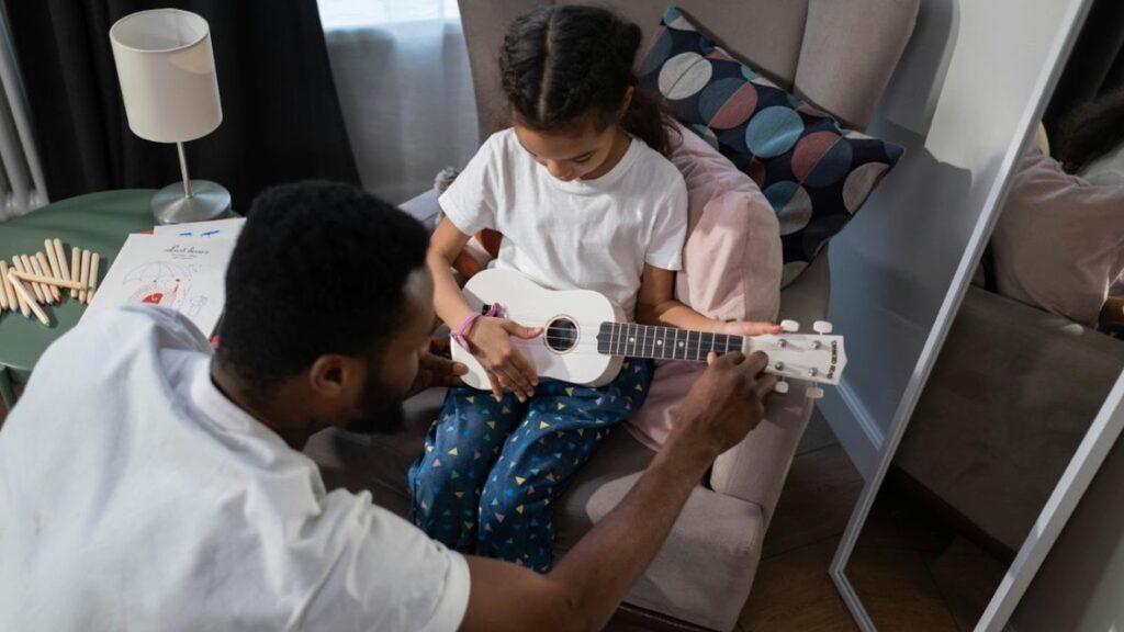 Child playing ukulele in music lesson