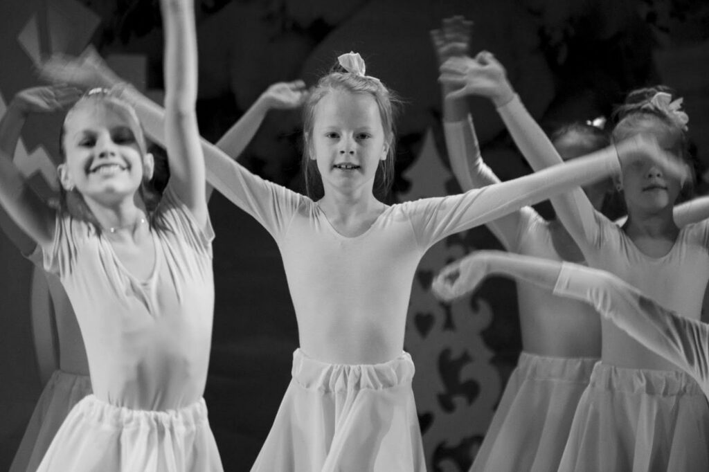 black and white photo of young ballerinas on stage