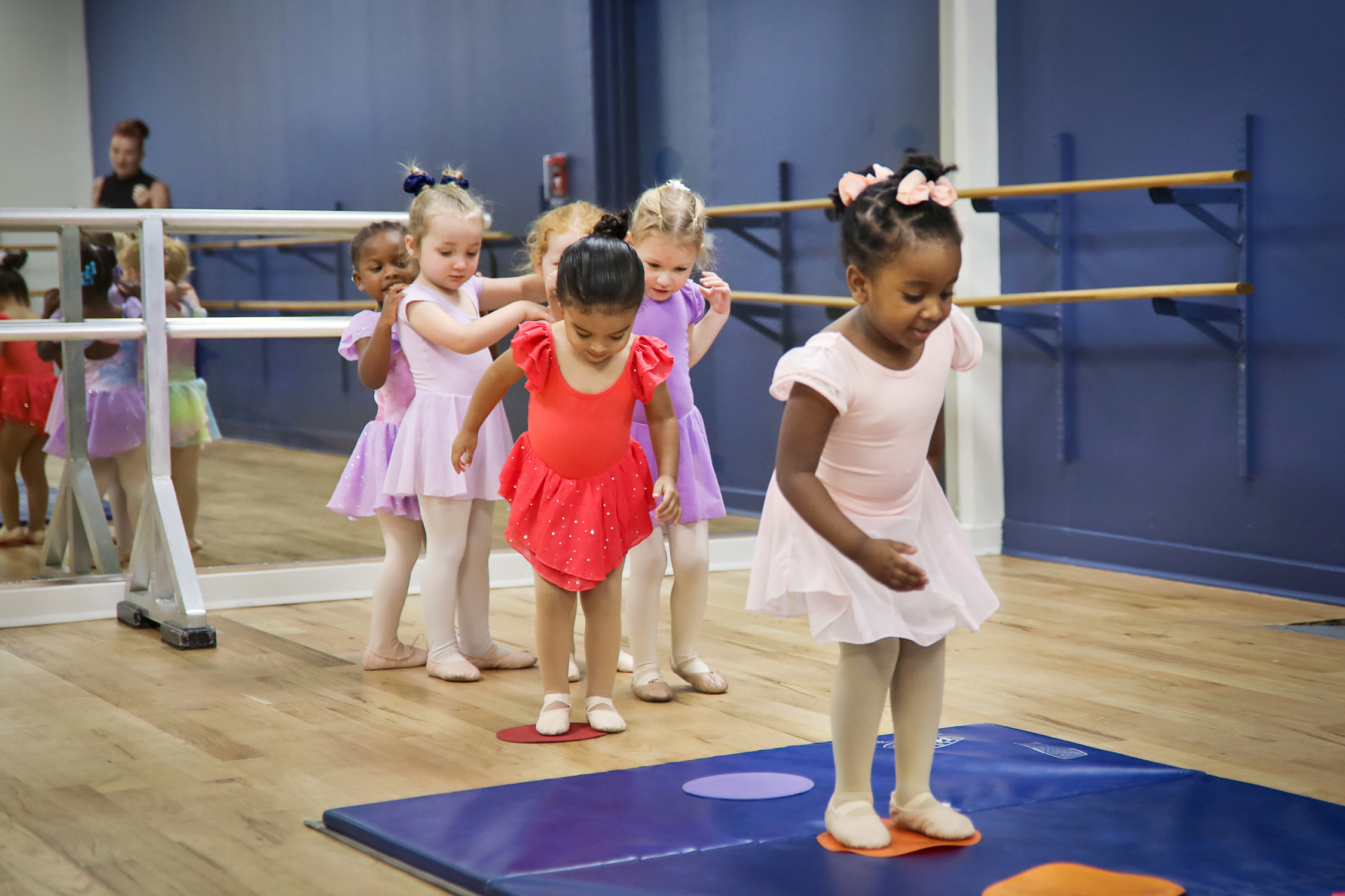 Dance class in a line jumping on dots