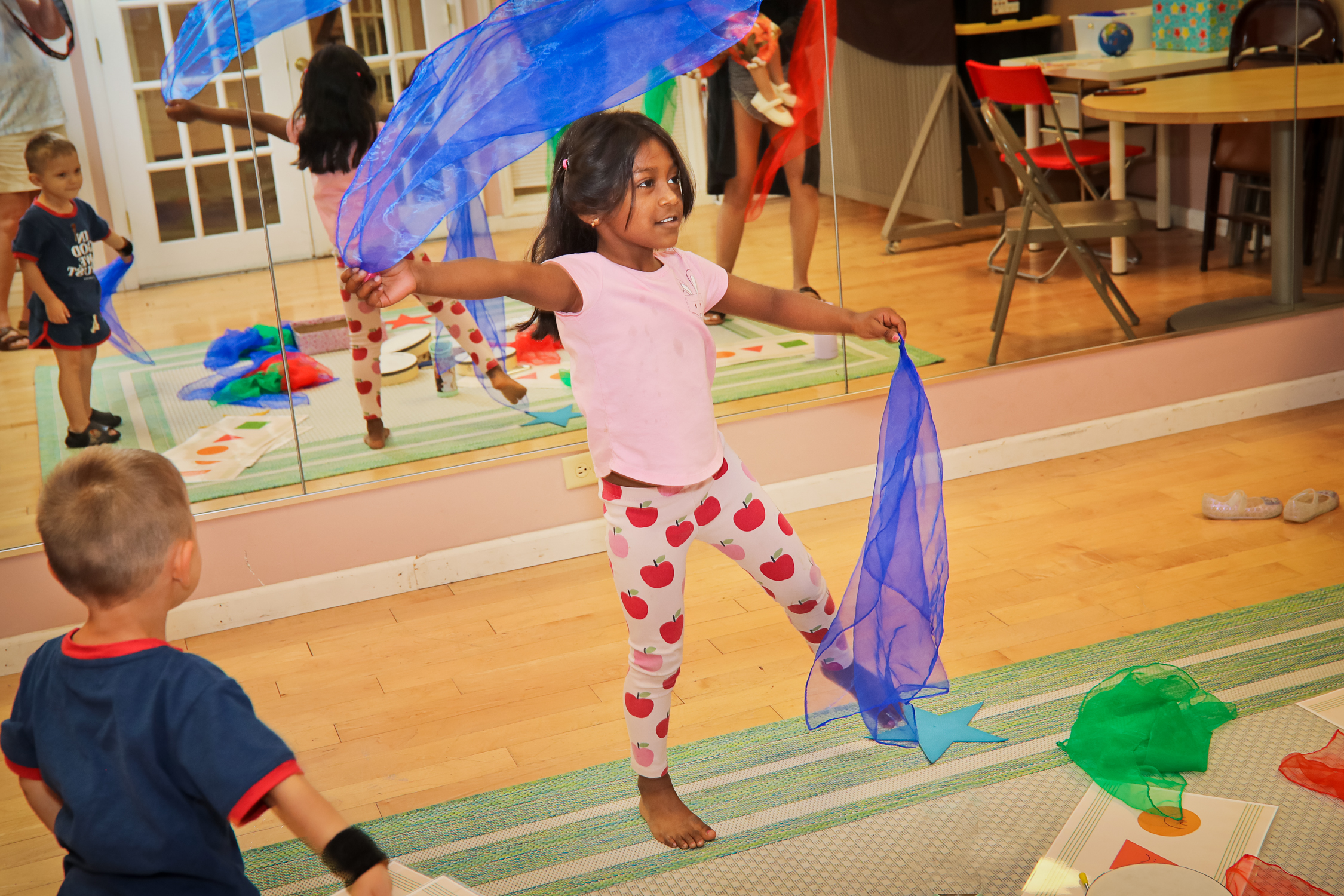 Child dancing with movement scarves